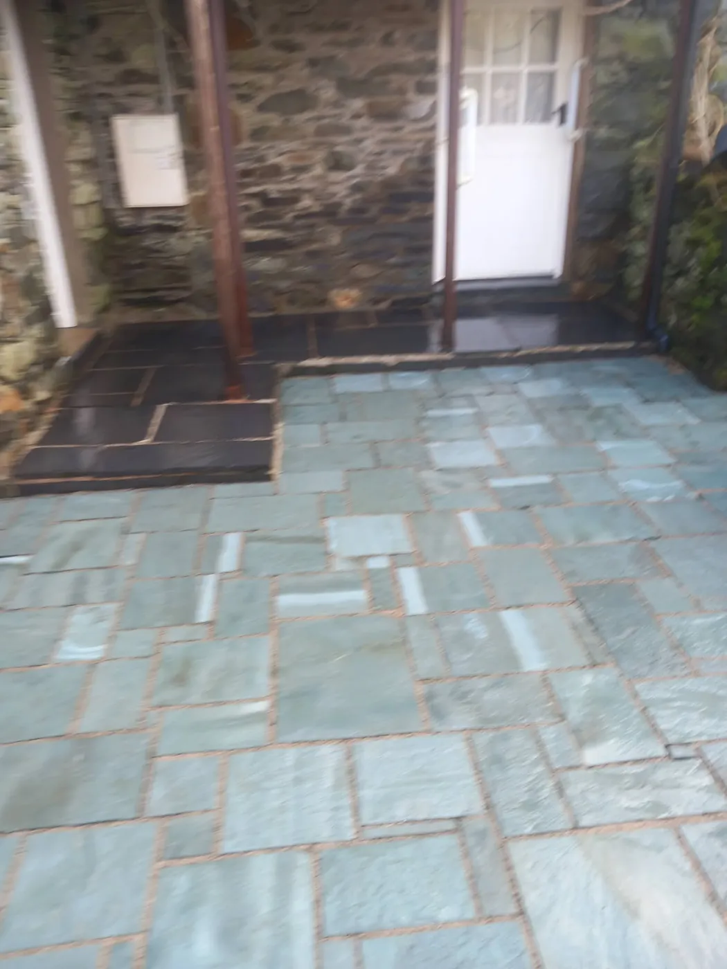 Slate flags at a cottage doorway — before and after cleaning — after